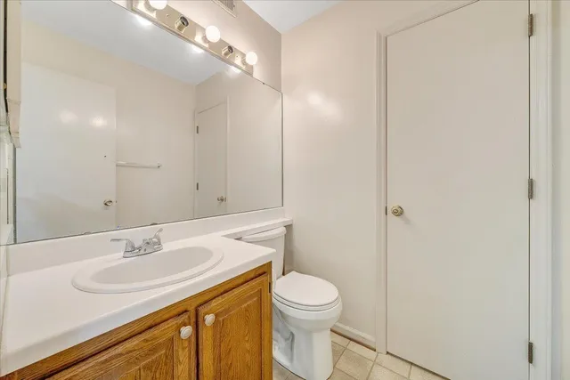 a bathroom with a sink toilet and vanity