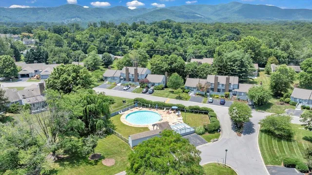 an aerial view of a house with a swimming pool patio and outdoor seating