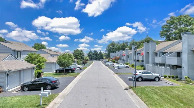 a view of a patio with couches and a fire pit and a yard