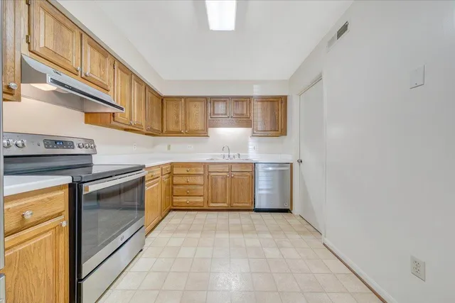 a kitchen with a stove top oven and cabinets