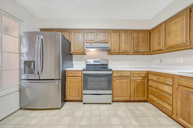 a kitchen with stainless steel appliances granite countertop a refrigerator sink and cabinets