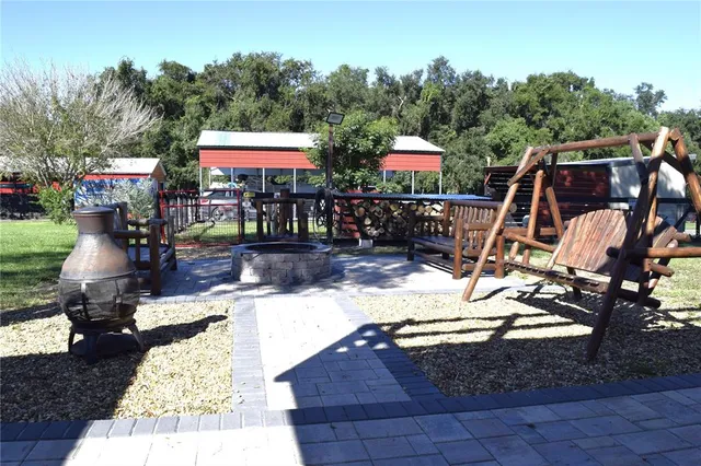 a view of a patio with table and chairs potted plants with wooden floor and fence