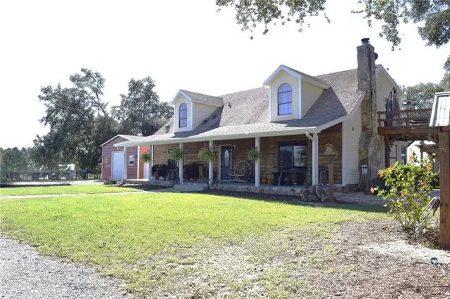 a view of a house with a yard and sitting area