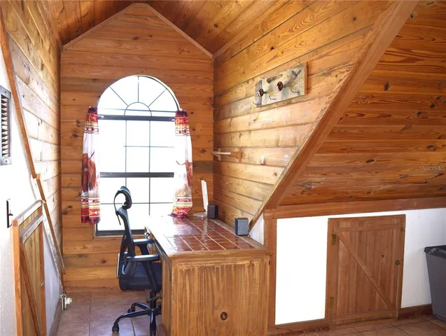 a view of a room with wooden floor and windows