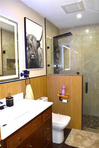 a bathroom with a toilet and a shower