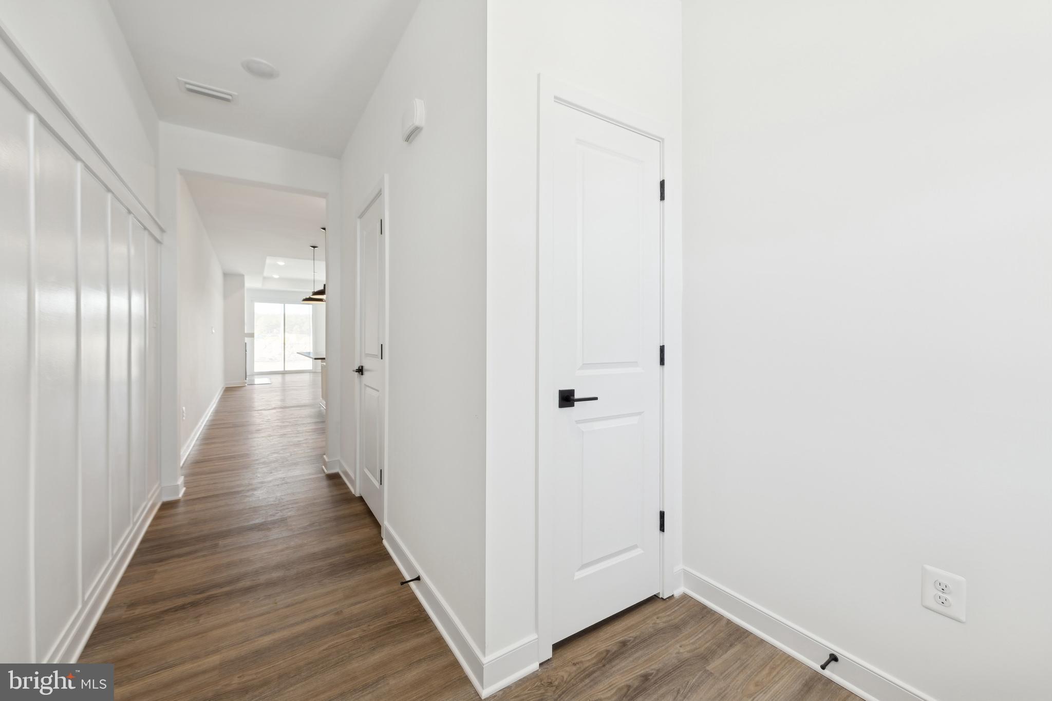 19711 Crows Nest Court Georgetown, DE 19947 - Photo 3 of 31 a view of a hallway with wooden floor