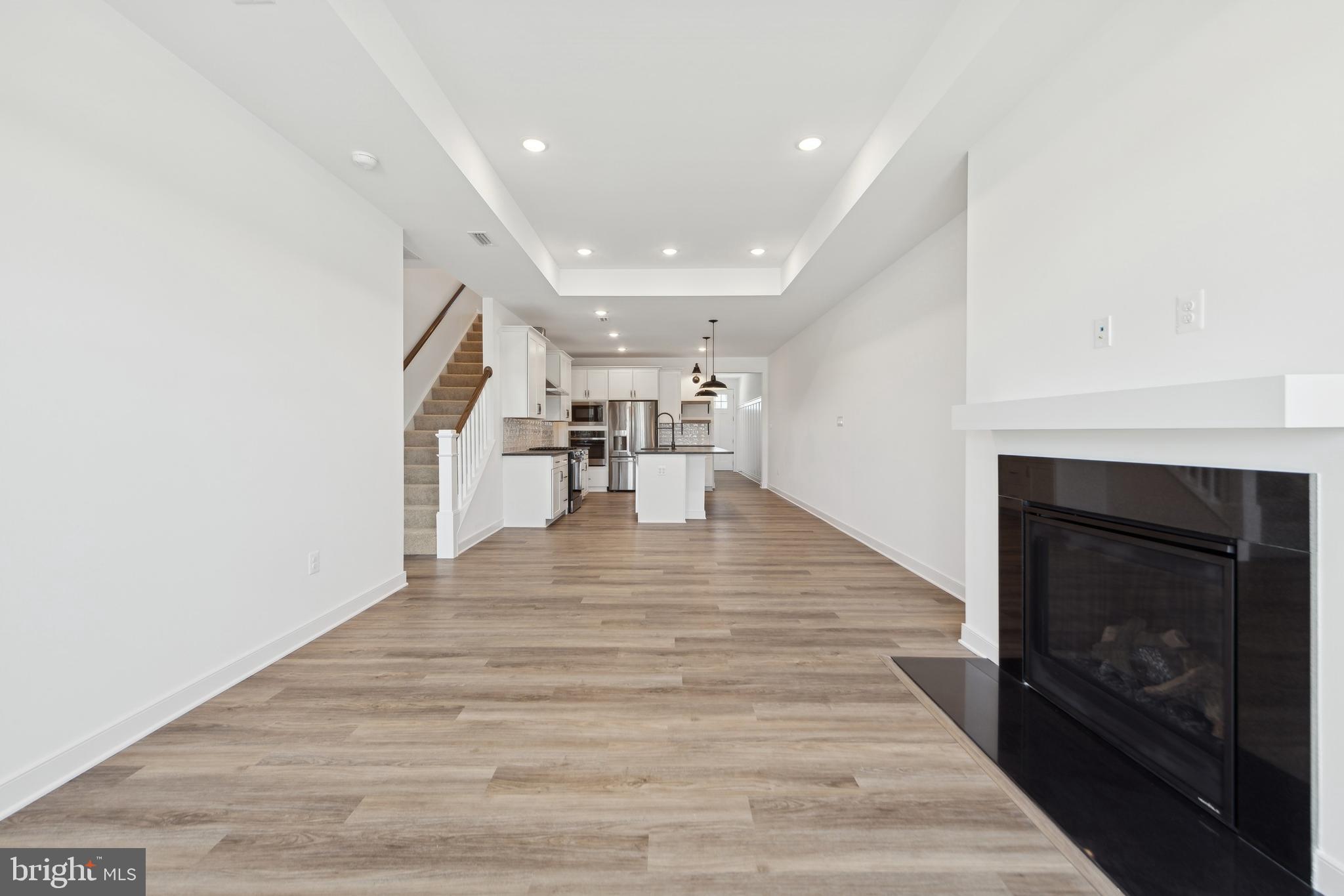 19711 Crows Nest Court Georgetown, DE 19947 - Photo 4 of 31 a view of a kitchen with a sink and a fireplace