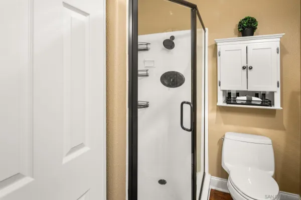 a bathroom with a toilet and a shower