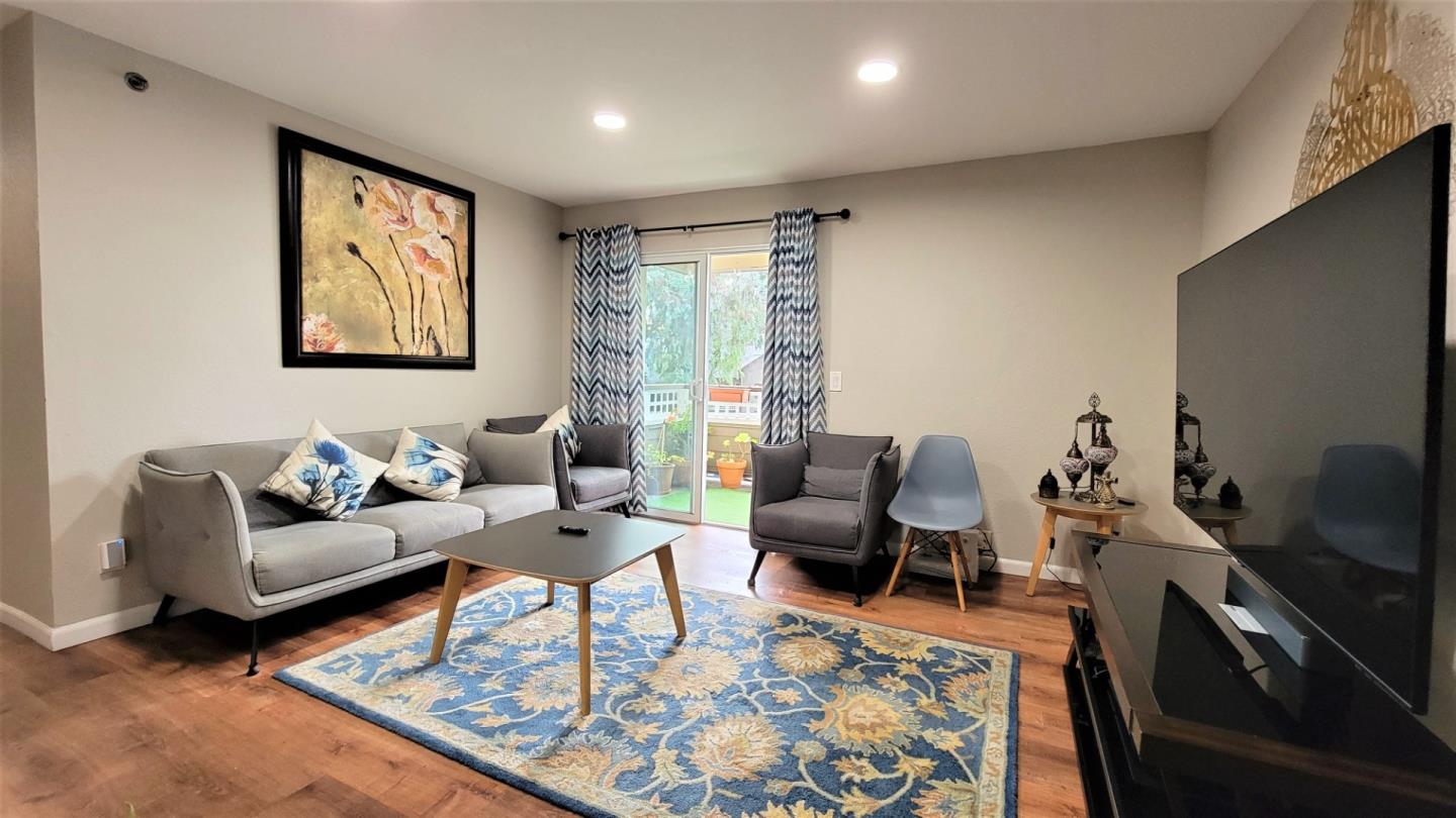 680 Dartmore Lane, Unit 259 Hayward, CA 94544 - Photo 13 of 25 a living room with furniture a rug and a flat screen tv