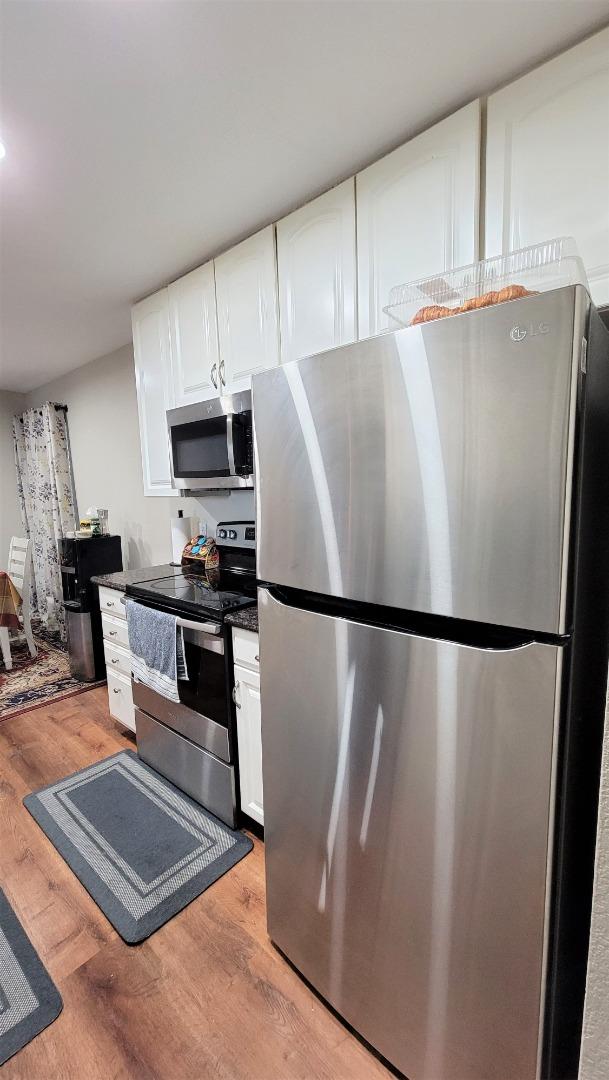 680 Dartmore Lane, Unit 259 Hayward, CA 94544 - Photo 21 of 25 a white refrigerator freezer sitting in a kitchen