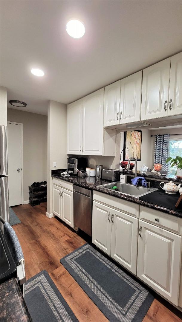 680 Dartmore Lane, Unit 259 Hayward, CA 94544 - Photo 23 of 25 a kitchen with granite countertop a sink cabinets and stainless steel appliances