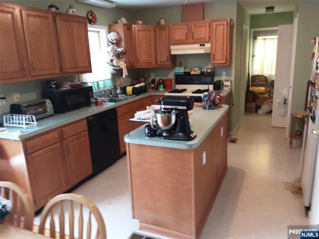 16 Crest Road Sussex, NJ 07461 - Photo 4 of 11 a kitchen with granite countertop a stove top oven a sink a counter top space and cabinets