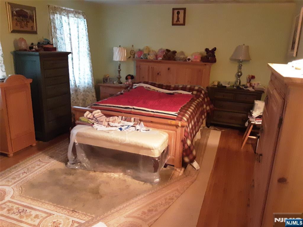 16 Crest Road Sussex, NJ 07461 - Photo 9 of 11 a bedroom with a bed and wooden floor