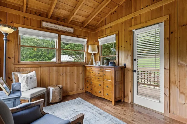 a living room with furniture and a floor to ceiling window