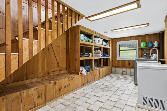 a view of a bedroom with a bed and a window