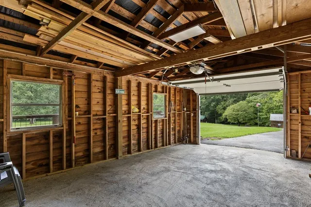 a view of a garden with a bench and trees around