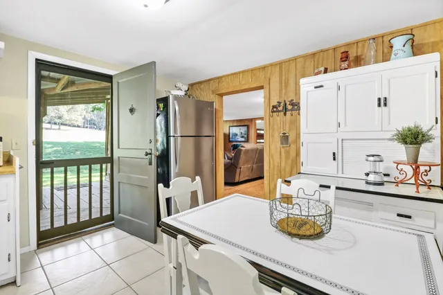 an aerial view of residential house with outdoor space and trees all around