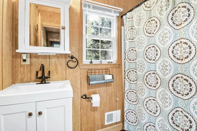 a backyard of a house with table and chairs