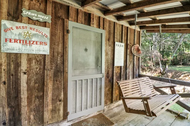an aerial view of a houses with a lush green hillside