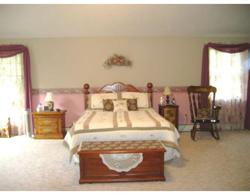 82 Wheeler Road Princeton, MA 01541 - Photo 11 of 25 a bed sitting in a spacious bedroom next to a window