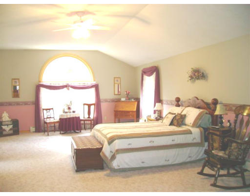 82 Wheeler Road Princeton, MA 01541 - Photo 12 of 25 a bedroom with a bed and a chandelier