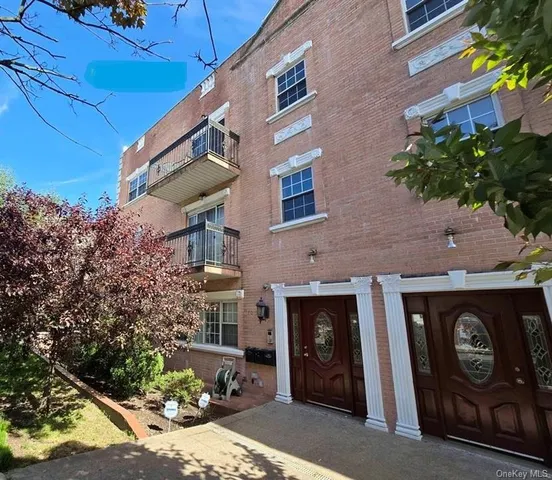 a front view of a building with garden