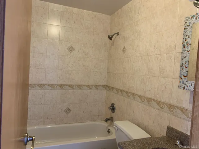 a bathroom with a shower and a bath tub