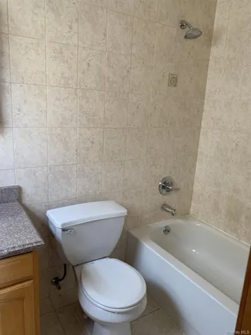 a white toilet and a bath tub