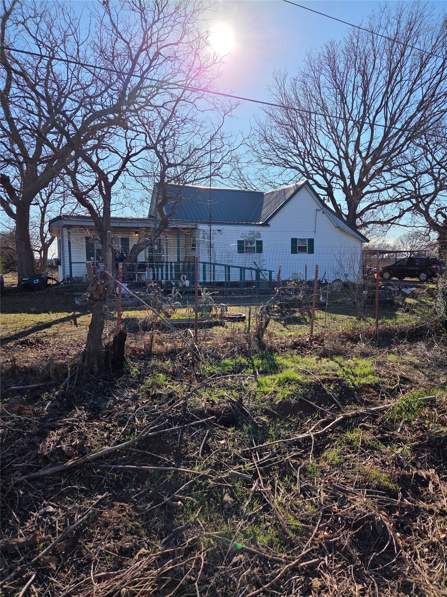 359149 East 1000 Road Paden, OK 74860 - Photo 5 of 13 White exterior featuring a front porch with railing, metal roof, and window shutters