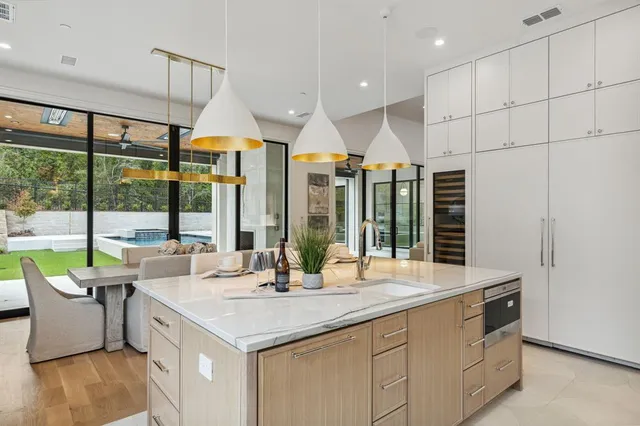a view of kitchen with granite countertop a sink and a counter top space