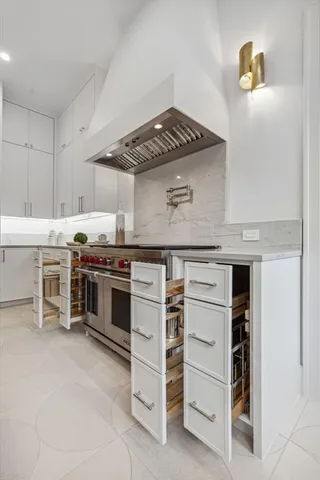 a kitchen with stainless steel appliances a stove and cabinets