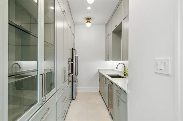 a kitchen with a sink and refrigerator