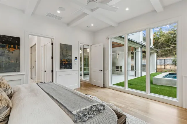 a spacious bedroom with a large window and walk in closet