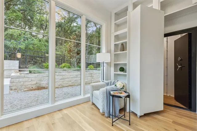 a living room with hardwood floor and a window
