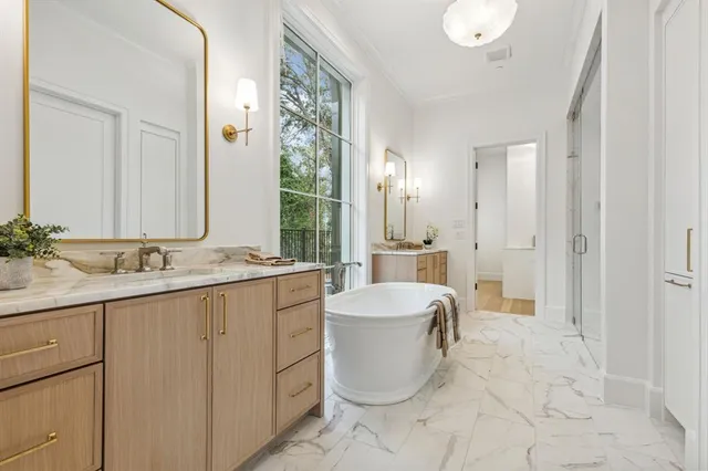 a bathroom with a granite countertop sink a toilet a mirror and shower