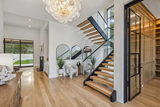 a view of entryway and hall with wooden floor