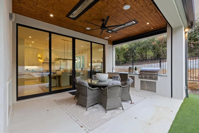 a dining room with furniture water view and a floor to ceiling window