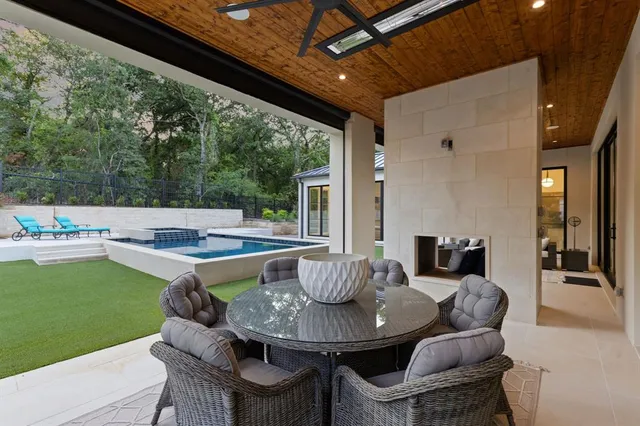 a view of an outdoor dining space with a table and chairs