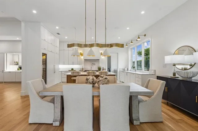 a view of a dining room with furniture and a chandelier