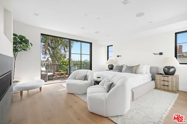 a bedroom with bed and a large window