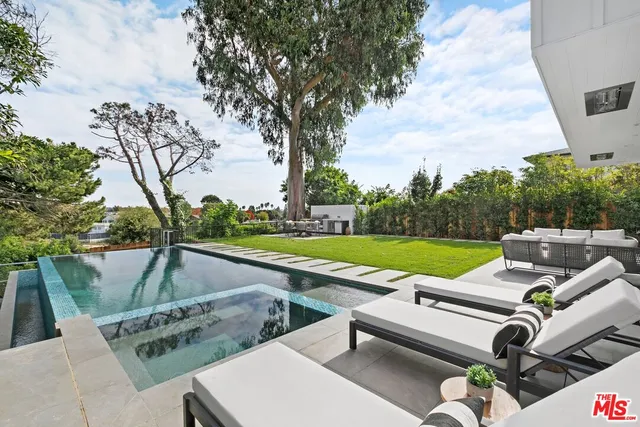 swimming pool view with a outdoor seating