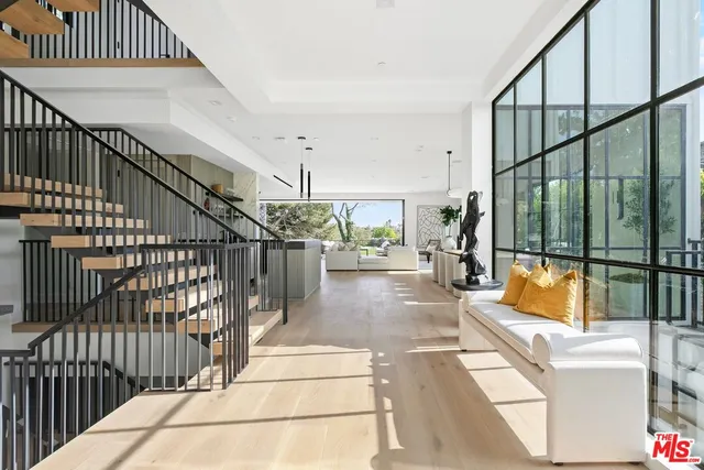 a view of entryway livingroom and hall with wooden floor
