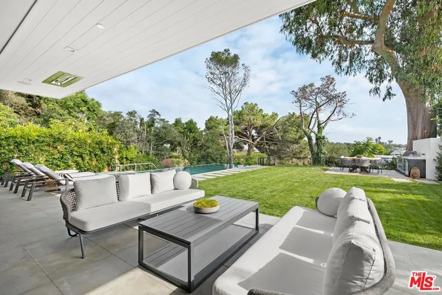 a view of a backyard with sitting area