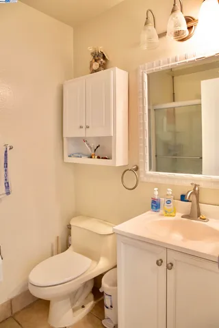 a bathroom with a toilet a sink and mirror