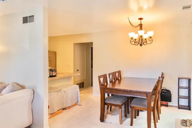 a view of a dining room with furniture and a potted plant