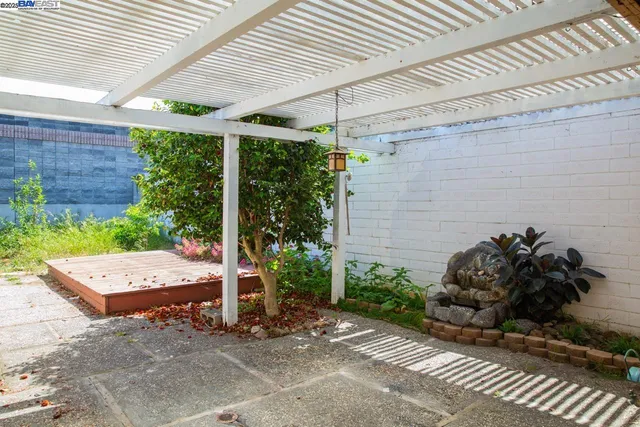 a view of a patio with table and chairs and potted plants