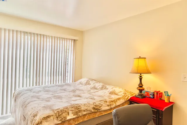 a bedroom with a bed and a window