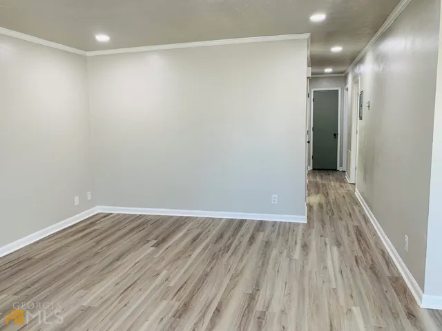 a view of hallway with wooden floor