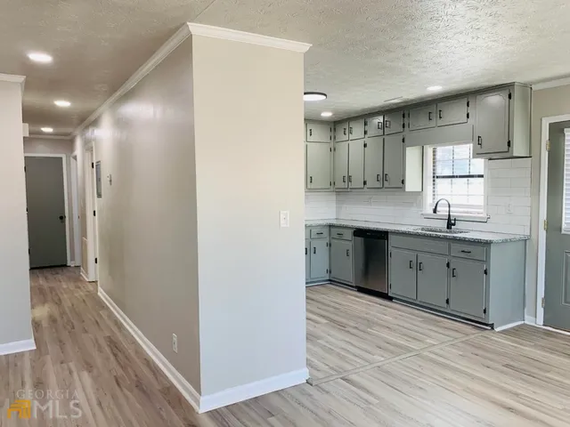 a kitchen with a sink stainless steel appliances and cabinets