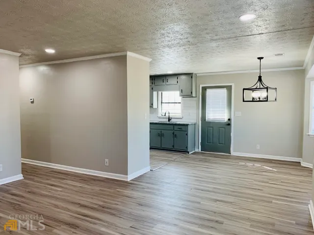 a view of a kitchen with a sink and wooden floor